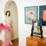 Artist Grace Zhang amidst her 'Spacetime Monologue' exhibition, showcasing her unique blend of art and finance.