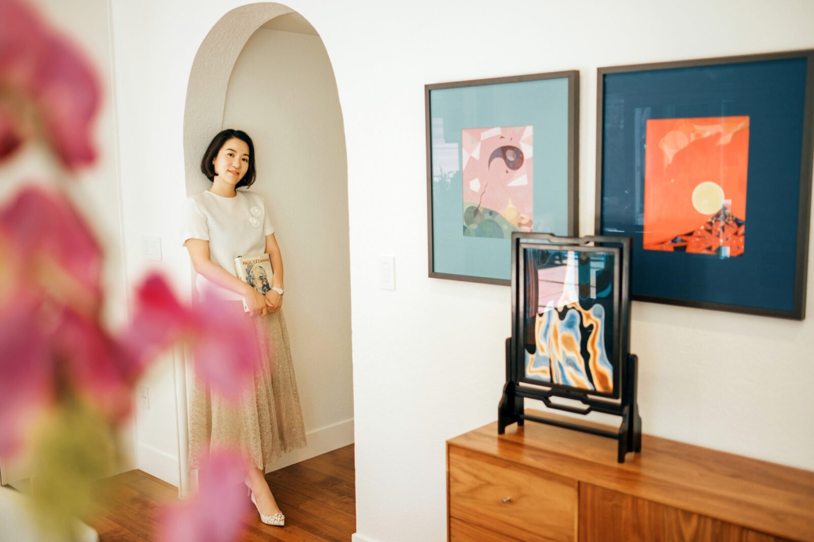 Artist Grace Zhang amidst her 'Spacetime Monologue' exhibition, showcasing her unique blend of art and finance.
