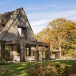 Victory Lap Residence: The Up Studio's Hamptons Masterpiece for Timeless Living 6 Modern Hamptons home exterior with pitched roof and natural surroundings designed by The Up Studio