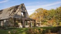 Modern Hamptons home exterior with pitched roof and natural surroundings designed by The Up Studio