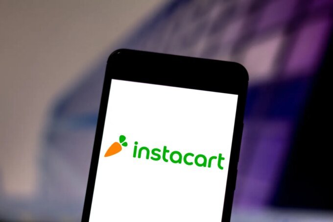 Logos of Instacart, DoorDash, and Uber representing potential merger discussions in the grocery delivery market.