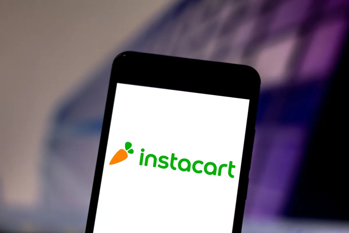 Logos of Instacart, DoorDash, and Uber representing potential merger discussions in the grocery delivery market.