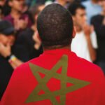 Un groupe de jeunes marocains engagés, discutant et souriant, symbolisant la participation active à la vie publique.