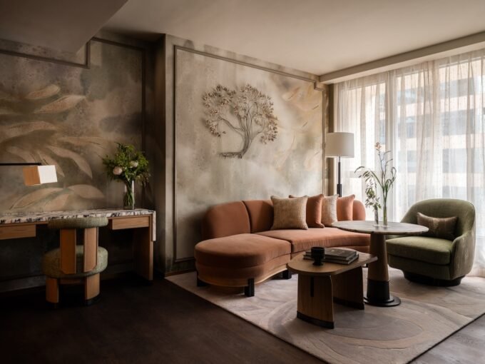 Luxurious lobby of Mandarin Oriental The Landmark, Hong Kong, showcasing Joyce Wang Studio's design with an undulating staircase and custom artworks.