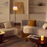 A cozy living room illuminated with warm, layered smart lighting for autumn ambiance.