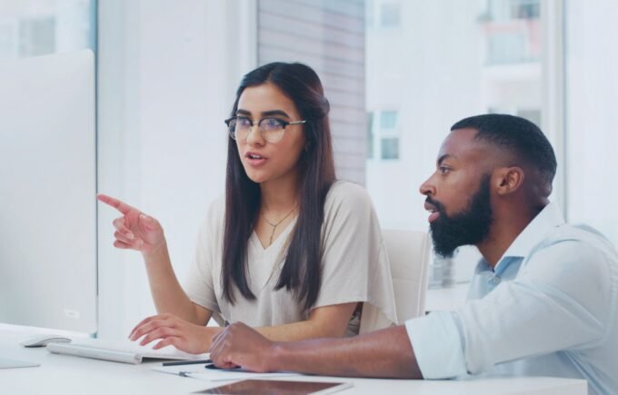 A leader looking into a mirror, seeing reflections of team members and systemic issues.