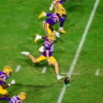 LSU and Auburn football players in action during a college football game.