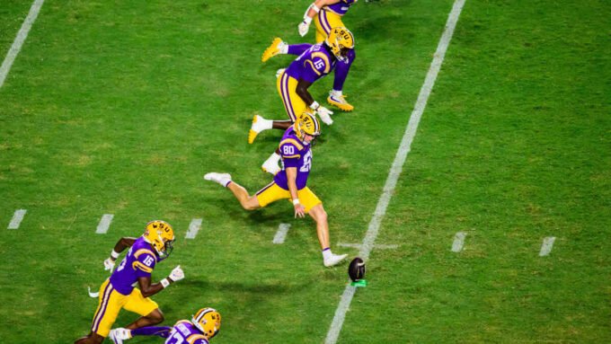 LSU and Auburn football players in action during a college football game.