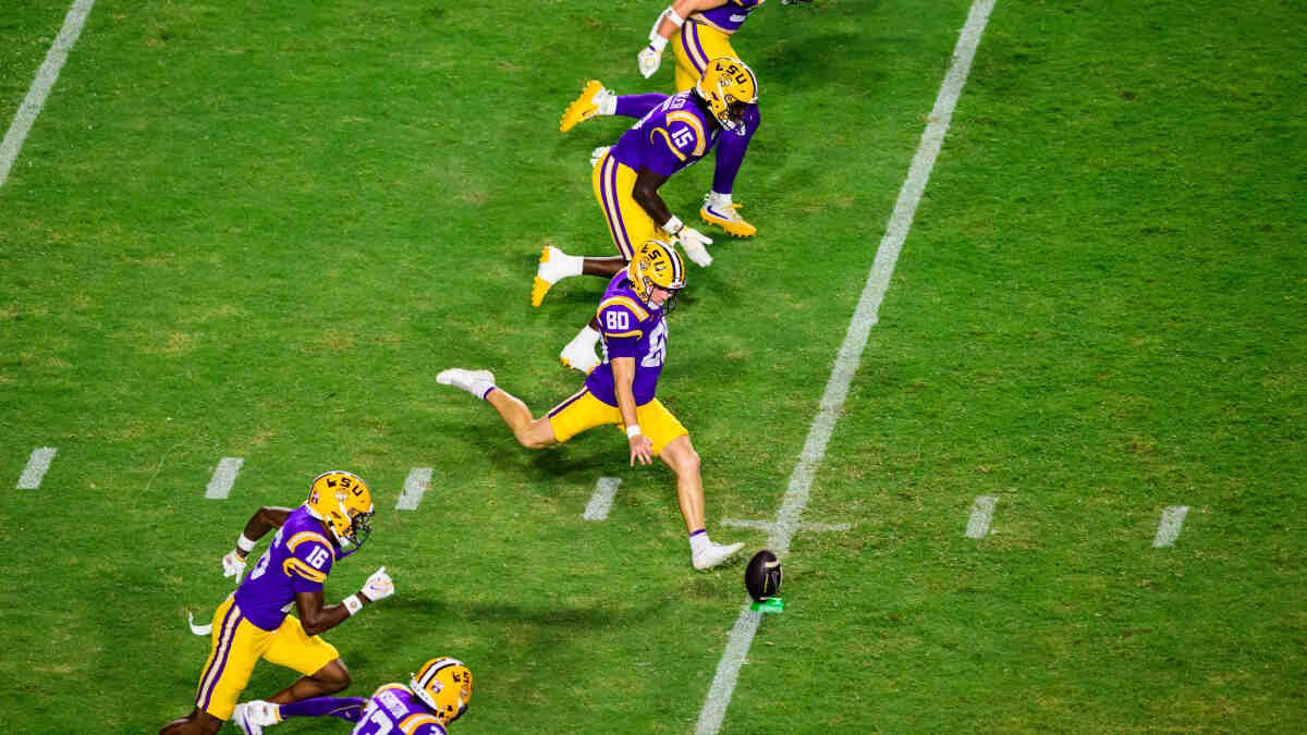 LSU and Auburn football players in action during a college football game.