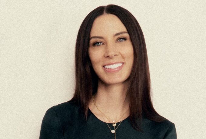 Sarah Gibson Tuttle, founder and CEO of Olive & June, smiling confidently.