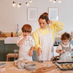 Children playing happily with supportive adults in a bright, safe environment, symbolizing positive childhood experiences.