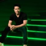 Razer CEO Min-Liang Tan with an AI hologram, symbolizing the fusion of gaming and artificial intelligence.