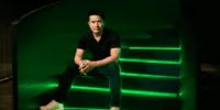 Razer CEO Min-Liang Tan with an AI hologram, symbolizing the fusion of gaming and artificial intelligence.