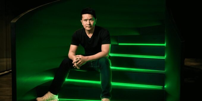 Razer CEO Min-Liang Tan with an AI hologram, symbolizing the fusion of gaming and artificial intelligence.