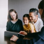 The Trust Economy: Why Branding Outperforms Marketing in Real Estate 8 A professional real estate agent shaking hands with a client, symbolizing trust and a strong brand relationship.