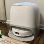 Roborock Qrevo CurvX robot vacuum and mop cleaning a floor in a modern home