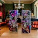 Ry Van Der Hout's 'Open Wing Death' sculpture, a 12-foot ovoid geodesic dome made of mirrored facets, installed in a historic room at Spadina Museum.