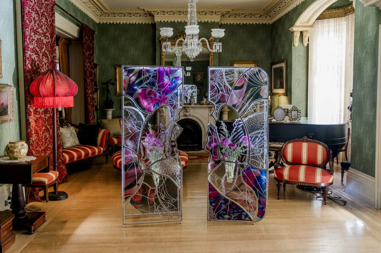 Ry Van Der Hout's 'Open Wing Death' sculpture, a 12-foot ovoid geodesic dome made of mirrored facets, installed in a historic room at Spadina Museum.