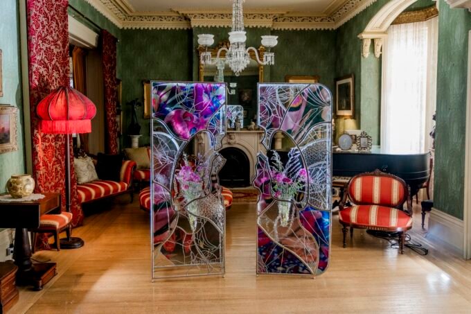 Ry Van Der Hout's 'Open Wing Death' sculpture, a 12-foot ovoid geodesic dome made of mirrored facets, installed in a historic room at Spadina Museum.