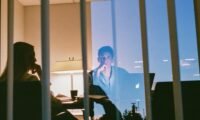 A person looking stressed while reviewing financial documents, symbolizing the struggle of mixed personal and business finances.
