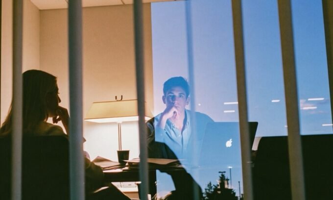 The Hidden Cost of Convenience: Why Your Single Bank Account is Keeping You Broke 10 A person looking stressed while reviewing financial documents, symbolizing the struggle of mixed personal and business finances.