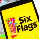 Six Flags Entertainment Corporation logo displayed on a smartphone screen