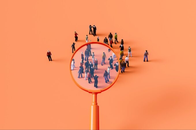 A business leader looking at a complex organizational chart with question marks, symbolizing the challenge of strategic hiring.