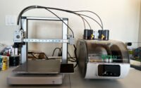 Sunlu AMS Lite Filament Heater integrated with a Bambu Lab AMS Lite unit, showing filament spools inside.
