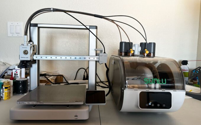 Sunlu AMS Lite Filament Heater integrated with a Bambu Lab AMS Lite unit, showing filament spools inside.