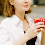 A steaming cup of black tea, symbolizing warmth and heart health, with a blurred background of a healthy lifestyle scene.