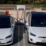Tesla vehicle with 'Assisted Driving' interface on screen, navigating European roads
