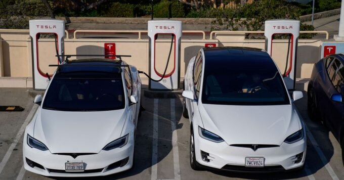 Tesla vehicle with 'Assisted Driving' interface on screen, navigating European roads