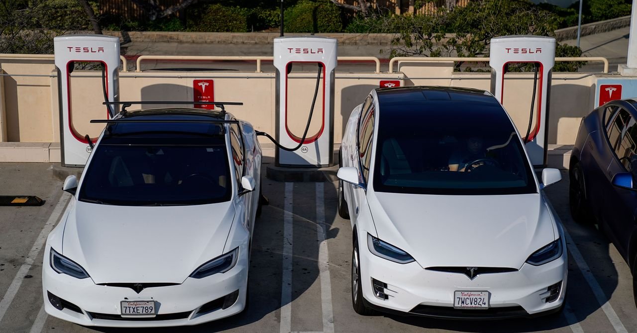Tesla vehicle with 'Assisted Driving' interface on screen, navigating European roads