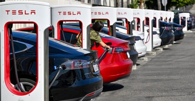 A Tesla vehicle quickly detaching from a Supercharger cable during an emergency, with the cable breaking away.