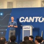 Tether CEO Paolo Ardoino speaking at an event, defending the company's sanctions compliance against allegations of facilitating illicit finance in Iran.