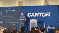 Tether CEO Paolo Ardoino speaking at an event, defending the company's sanctions compliance against allegations of facilitating illicit finance in Iran.