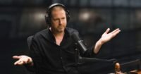 Tim Heidecker in character, mimicking Joe Rogan's podcast style for The Tim Heidecker Podcast on The Onion