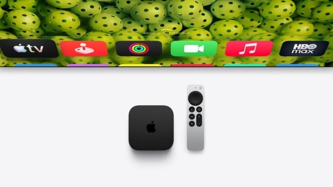 Apple TV 4K device with Siri Remote on a modern media console, displaying a vibrant tvOS screen saver.