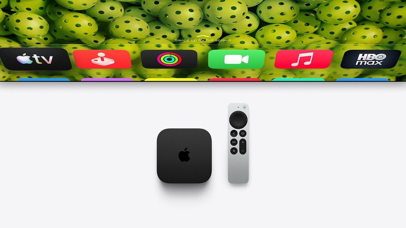 Apple TV 4K device with Siri Remote on a modern media console, displaying a vibrant tvOS screen saver.