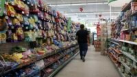 Bags of candy displayed on store shelves, symbolizing consumer goods affected by inflation.