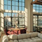 A modern duplex living space in Williamsburg, Brooklyn, featuring high ceilings, large steel-framed windows, and elegant interior finishes.