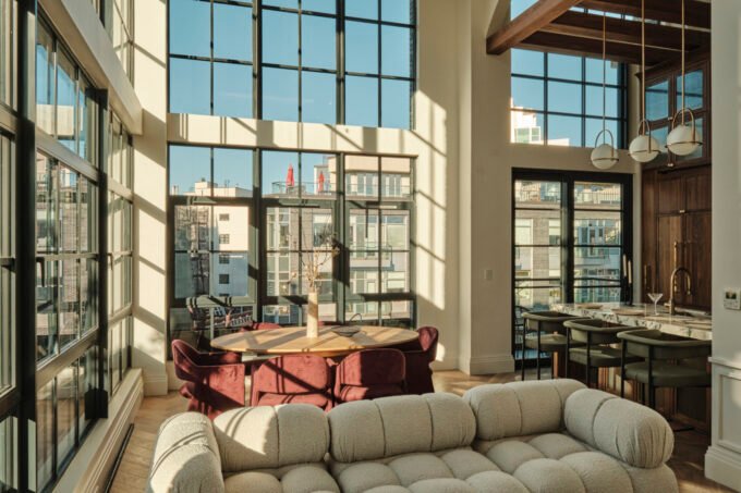 A modern duplex living space in Williamsburg, Brooklyn, featuring high ceilings, large steel-framed windows, and elegant interior finishes.
